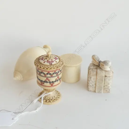 Four small ivory containers.
